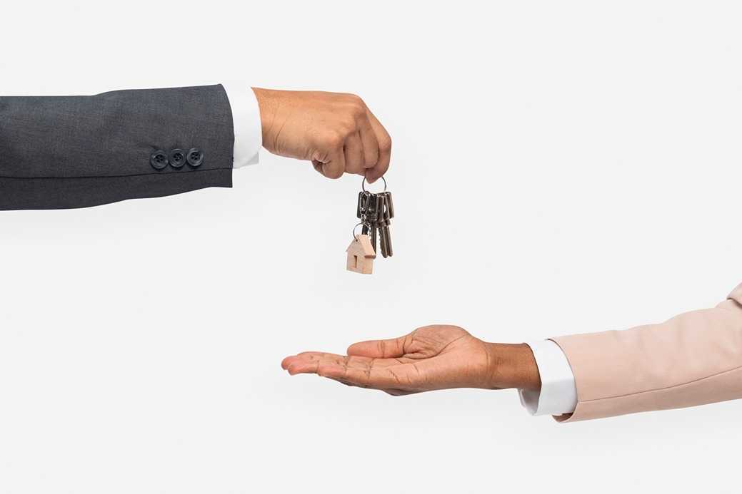 hand-giving-key-real-estate-agent